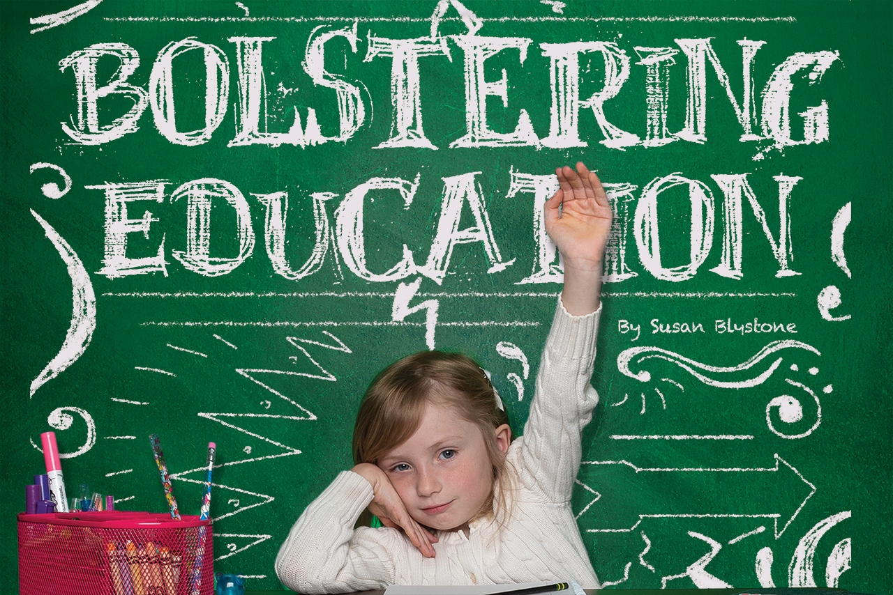 Bolstering education on chalkboard behind student raising her hand