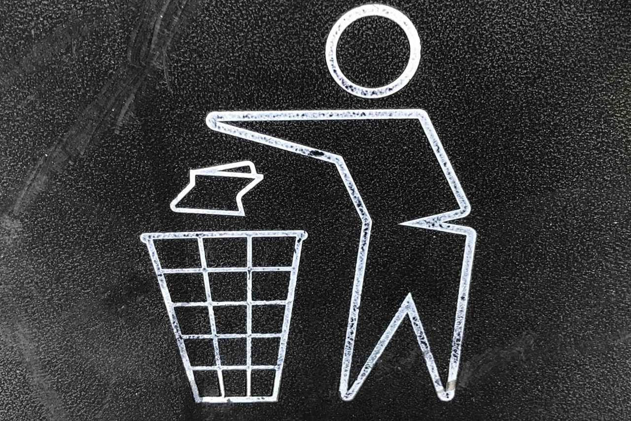 Photo by Gary Chan on Unsplash stick figure throwing away trash in a trash can