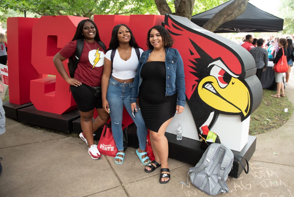 Students in front of ISU letters.