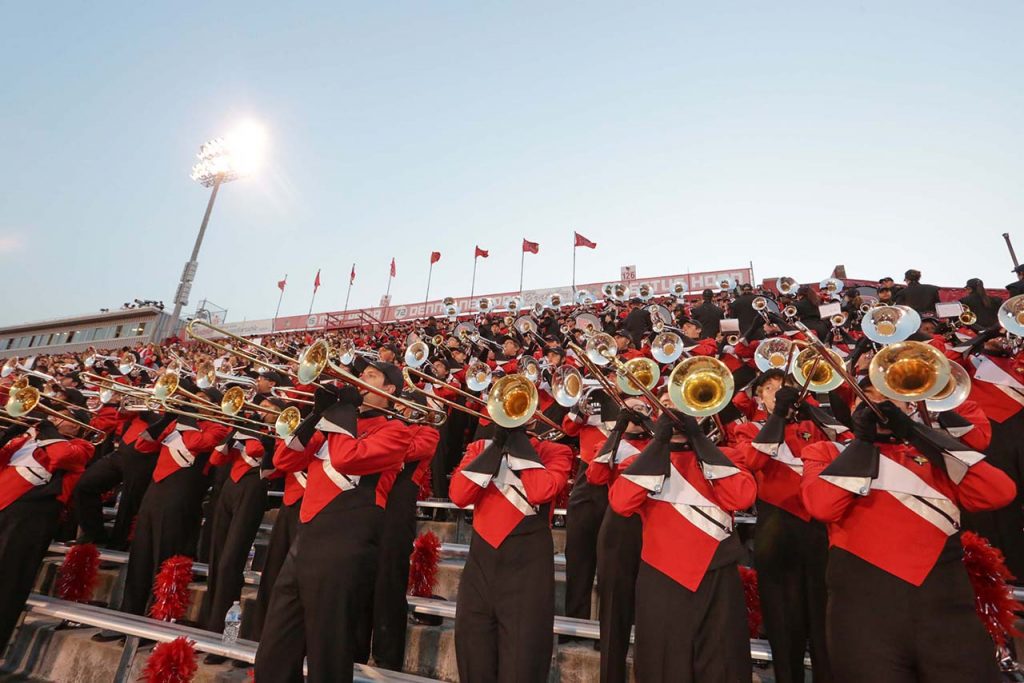 Big Red Marching Trombone Section in stands at Handcock Stadium