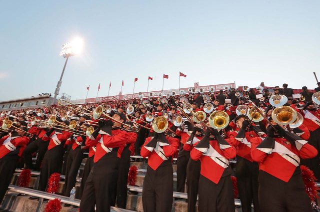 Big Red Marching Machine Trombone Section in stands at Handcock Stadium