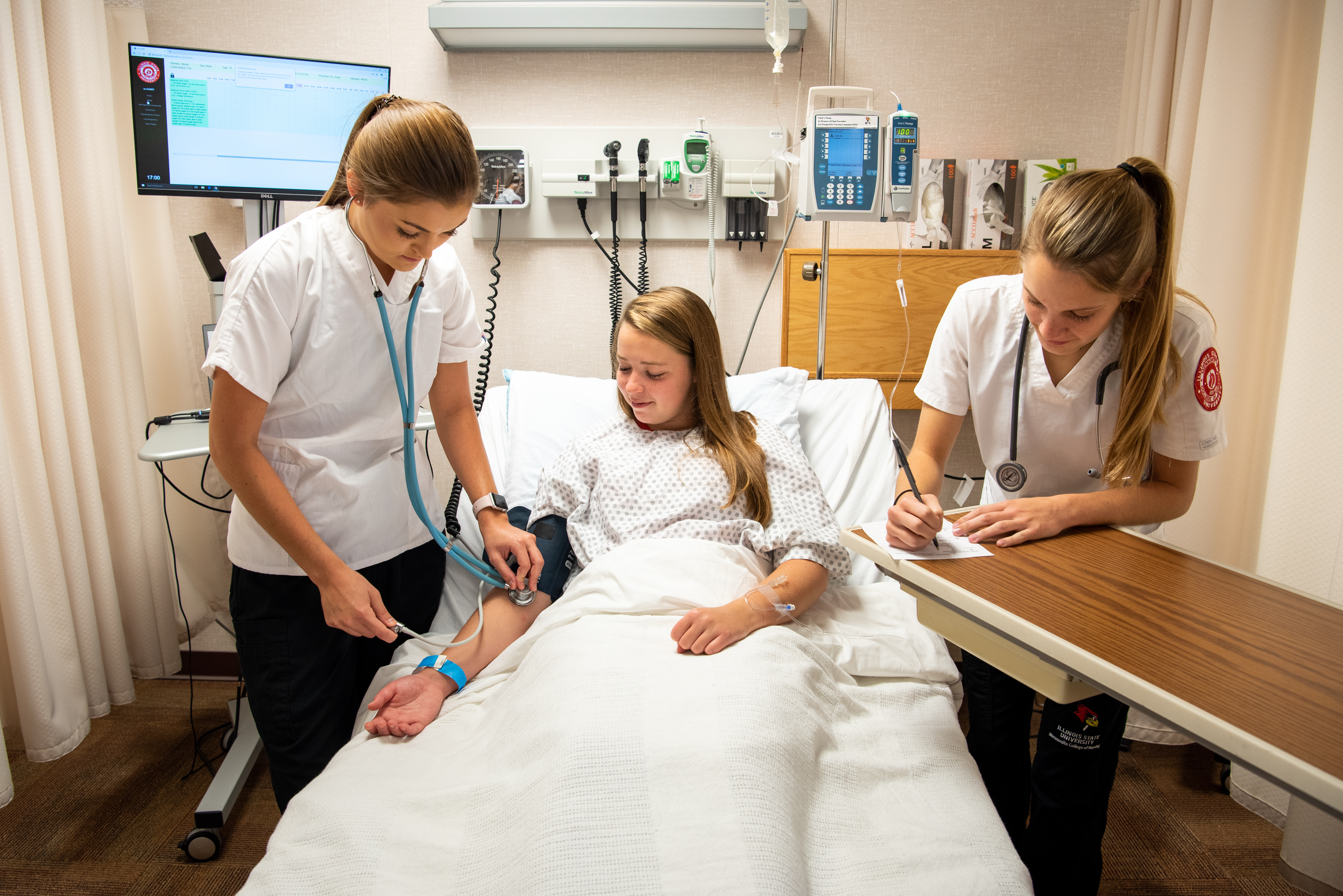 Nursing students Morgan Bangert (left), Elise Austin, and Kari Lalumandier participate in a training at the Nursing Simulation Lab.