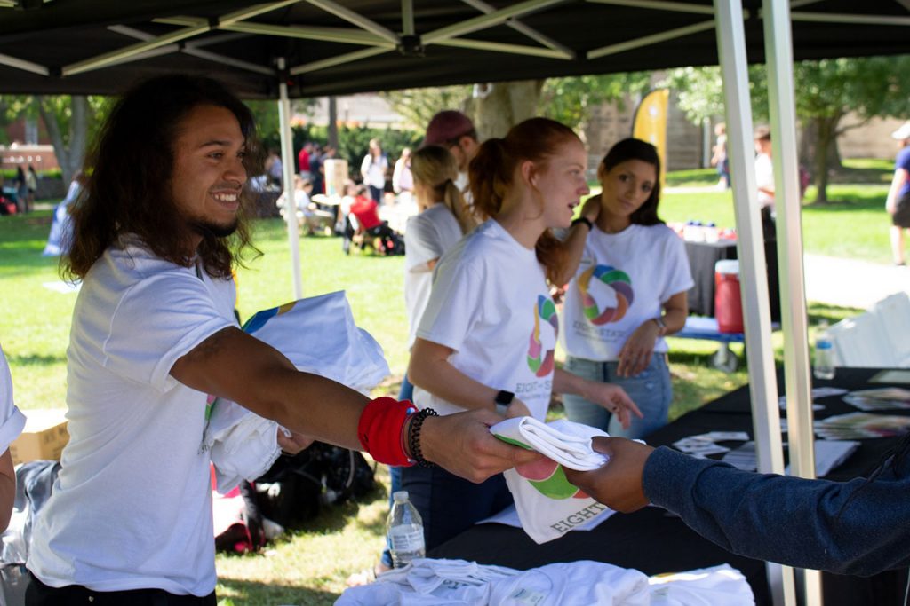 Students and staff distribute t-shirts to promote the new Eight at State wellness campaign