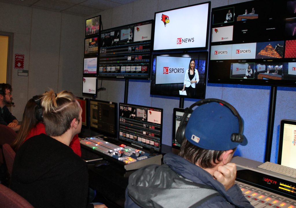 Students in TV-10 studios looking at monitors.