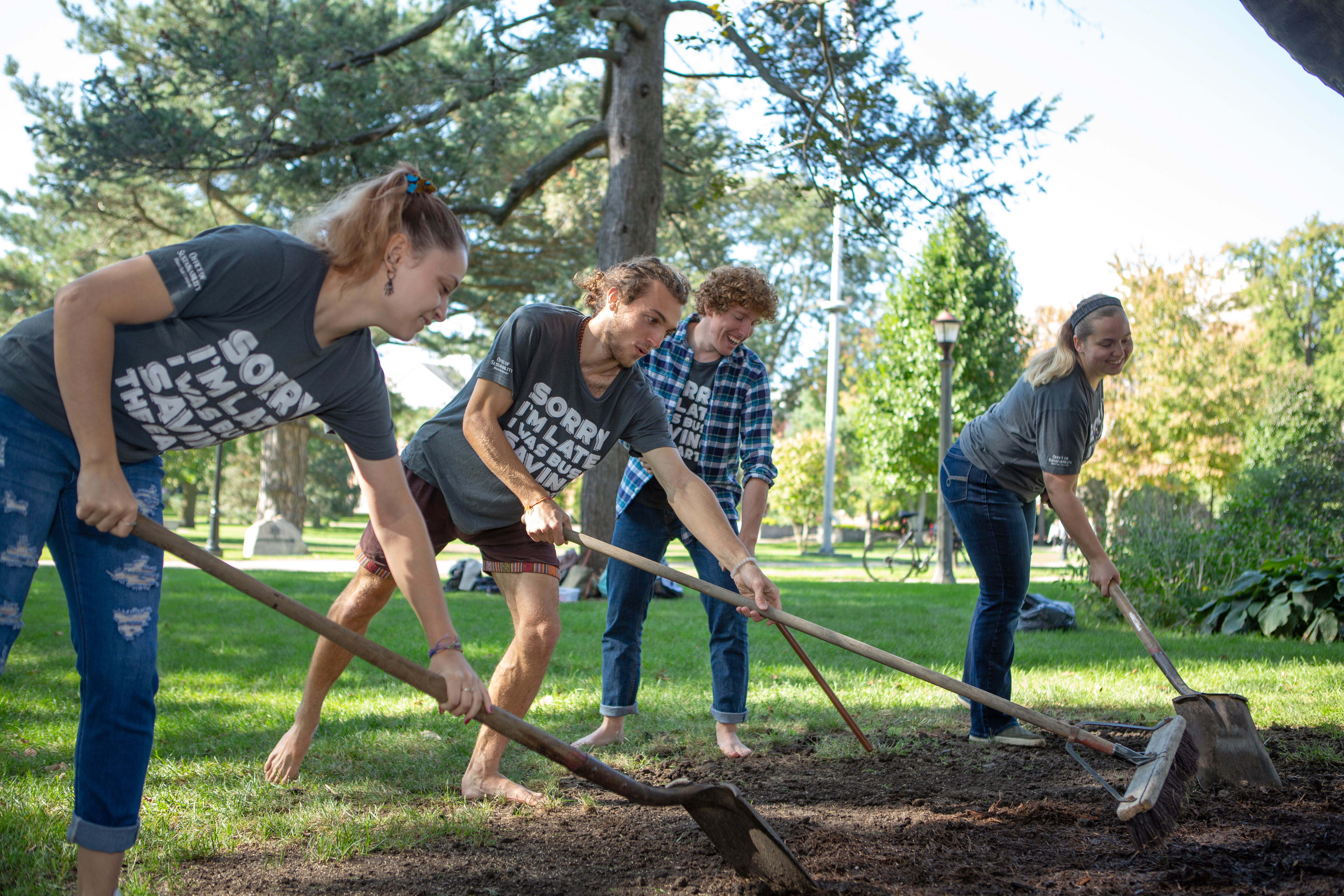 Students raking dirt in the Quad