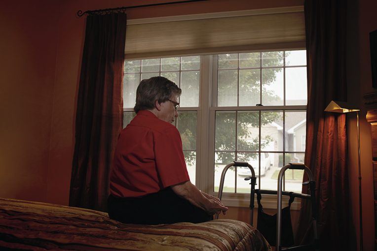 Woman alone in a nursing home room