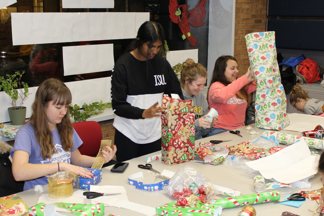 students wrapping holiday gifts