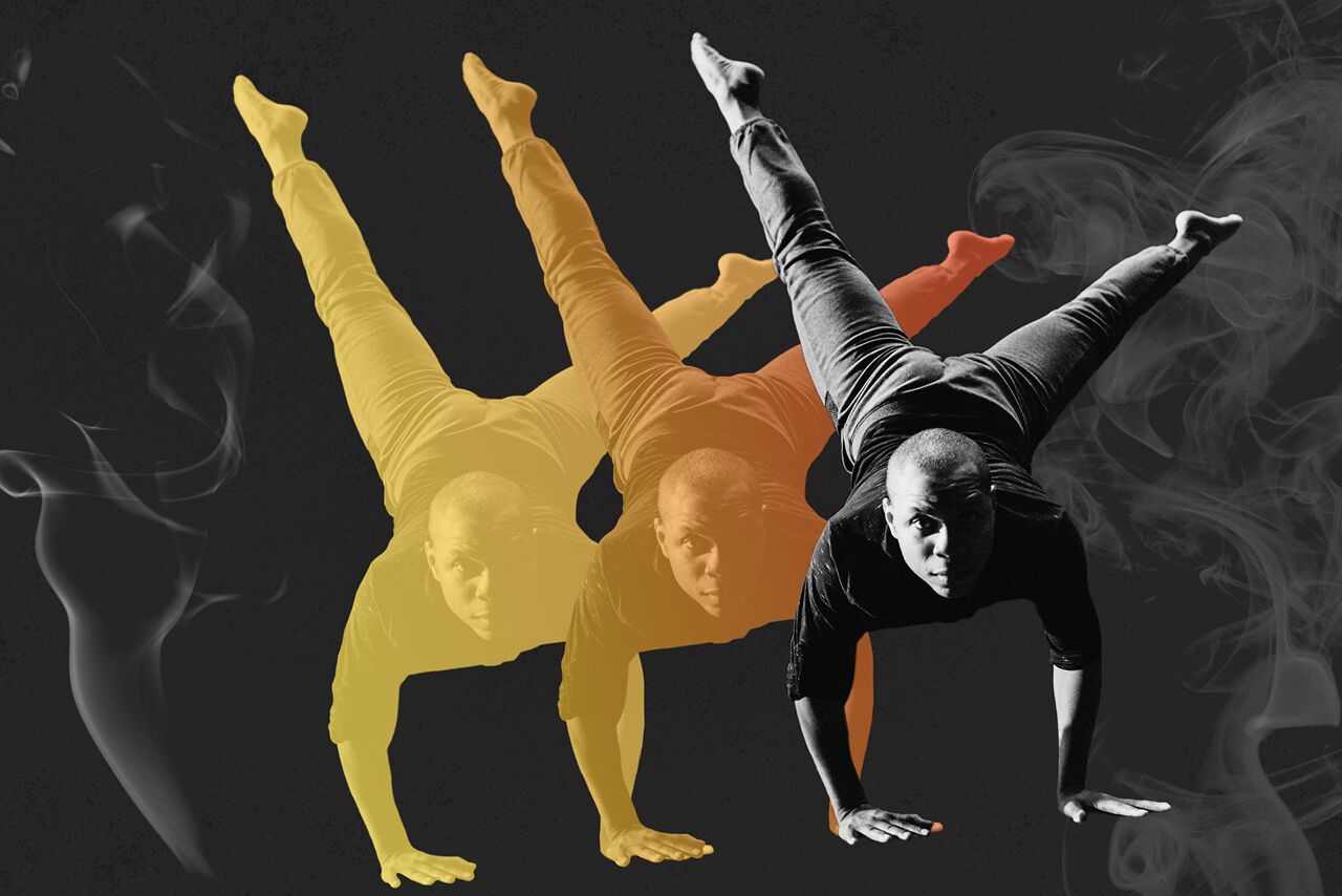 Image of dancer in a handstand like pose with smoke graphic following his orange and yellow shadows..