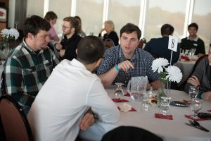 Student talking to other attendees at an event