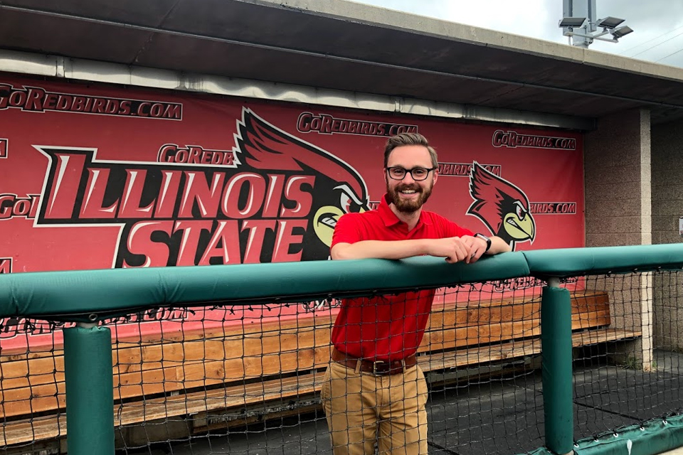 Person standing in Illinois State baseball dugout
