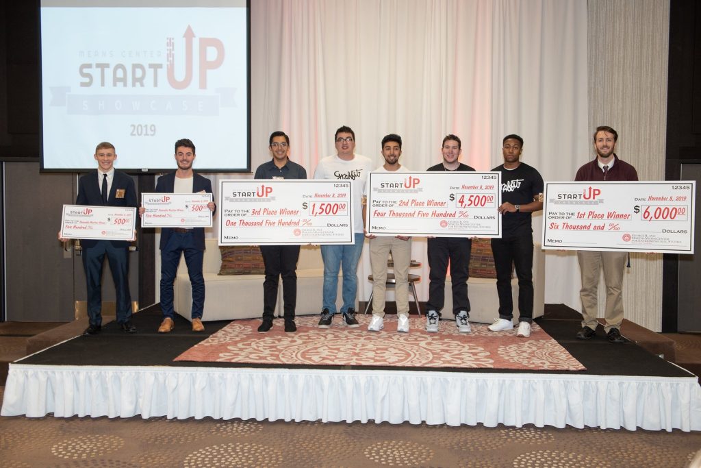 Startup Showcase winners with checks.