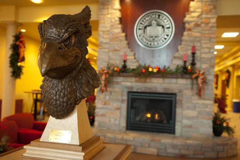 bust of Reggie in front of fireplace