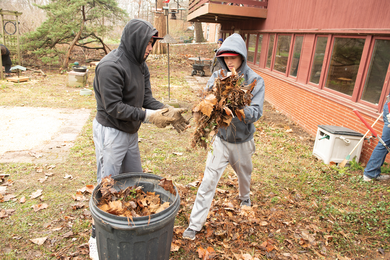 Students cleaning up leaves