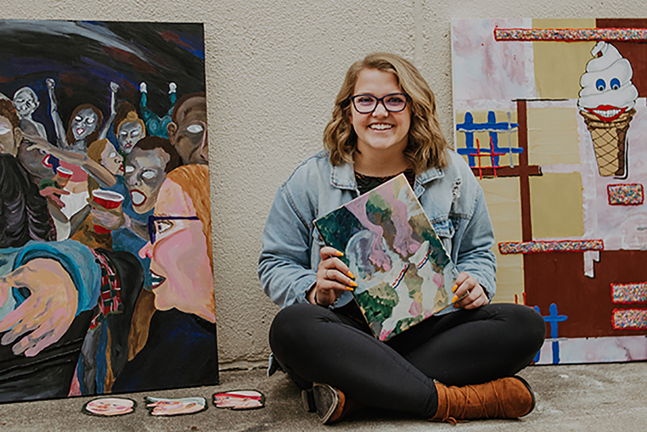 Art student Emily Minton poses with her artwork