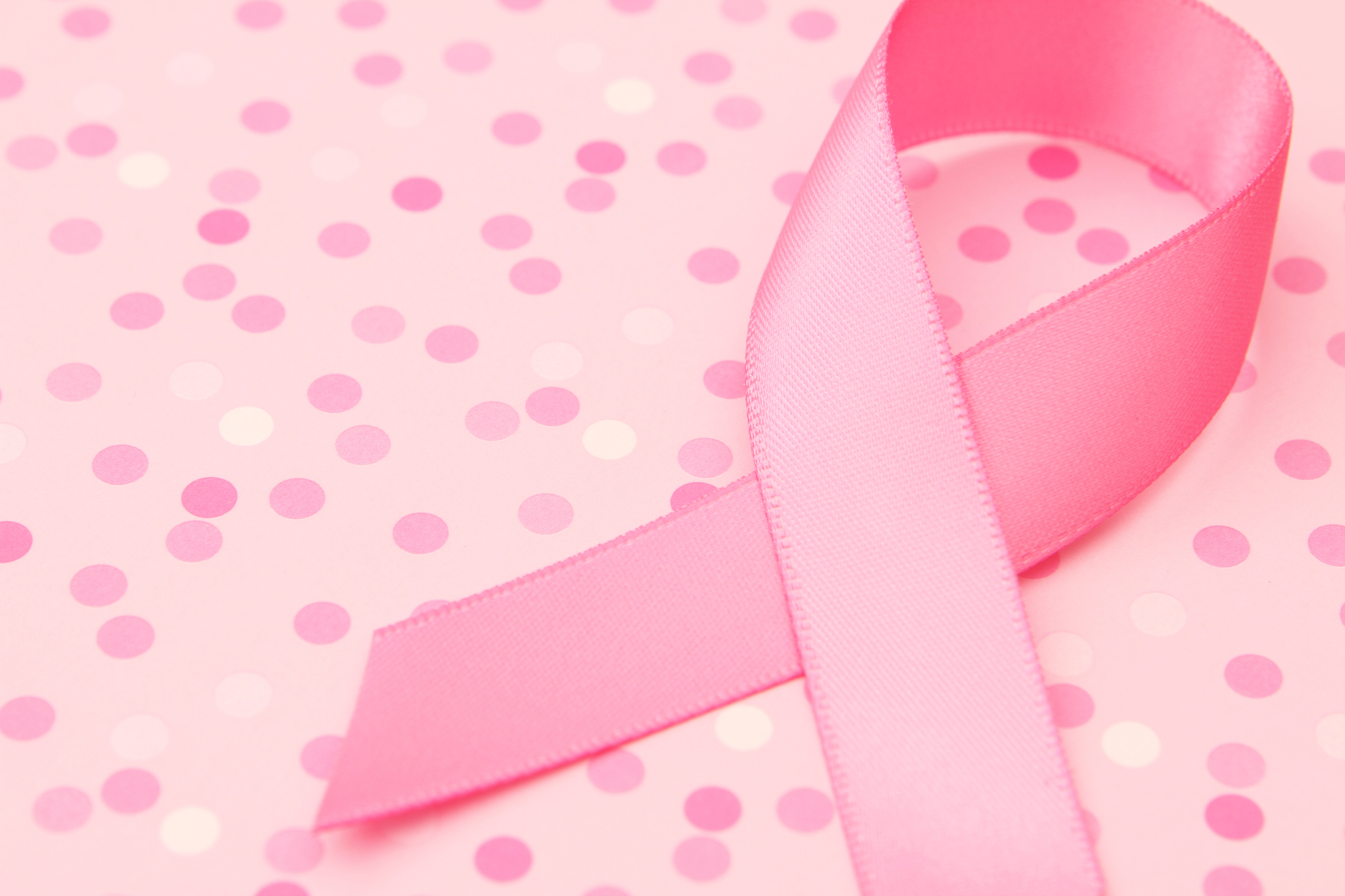 pink ribbon on polka dot background