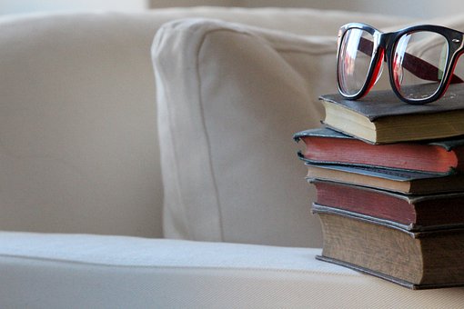 Books stacked on a couch