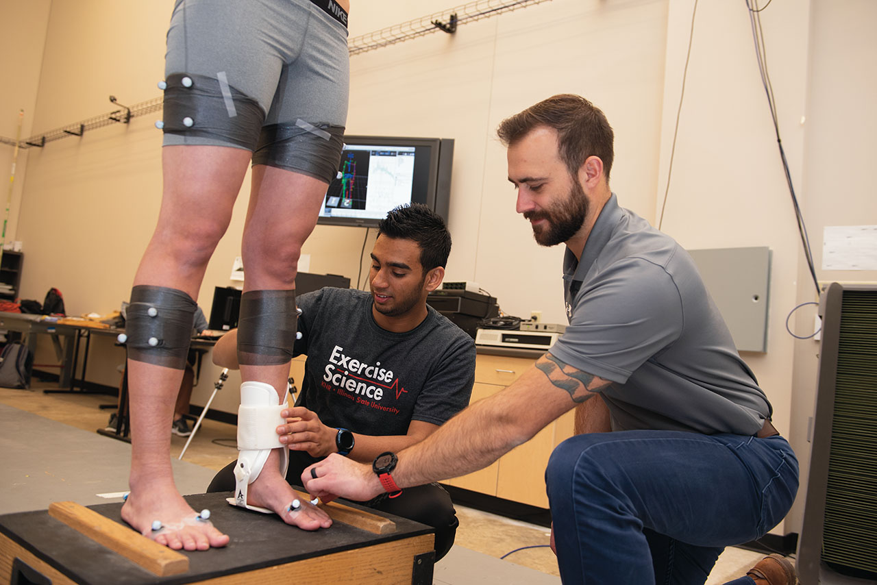 Student and professor studying ankle braces.