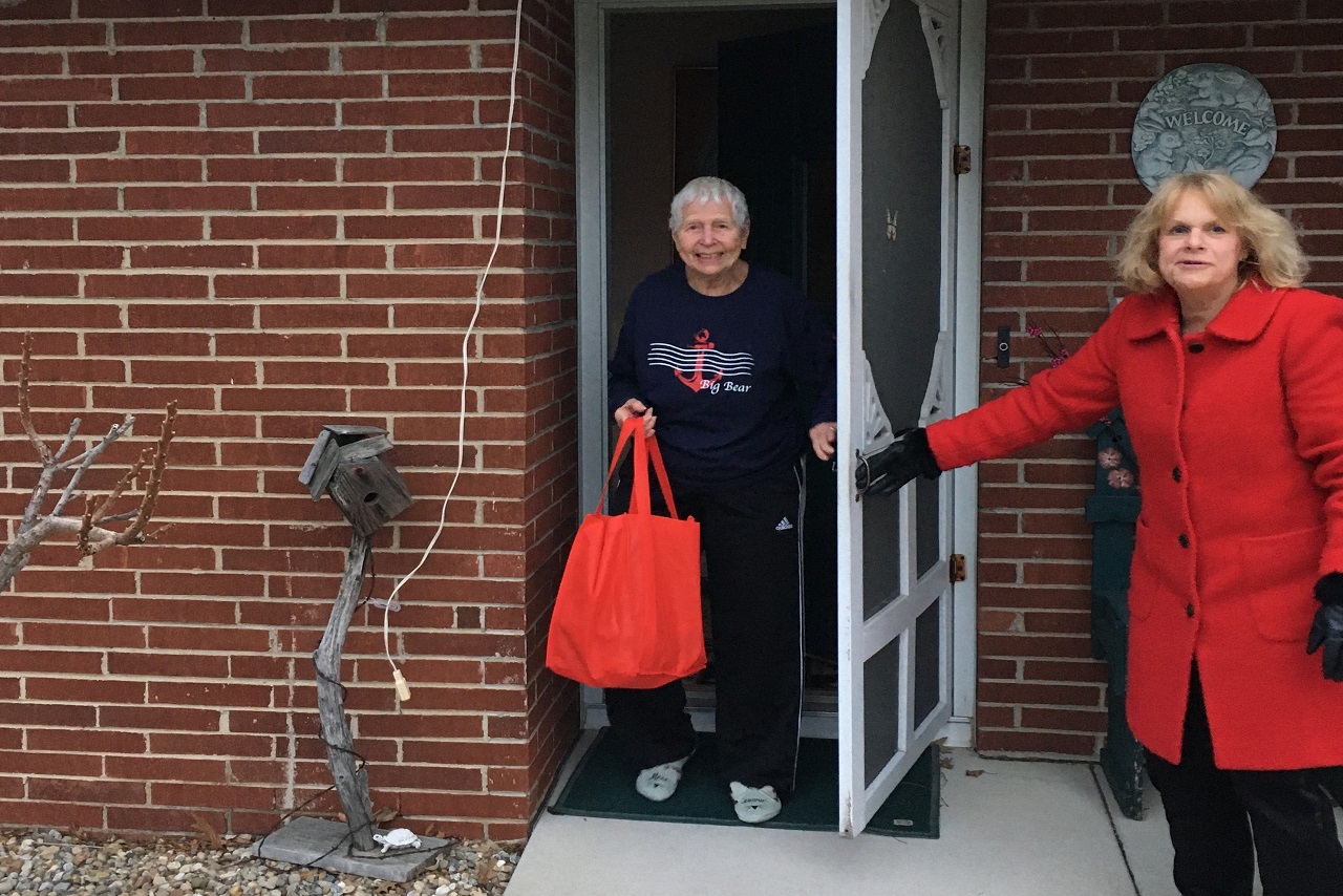 Woman delivers care package to another woman