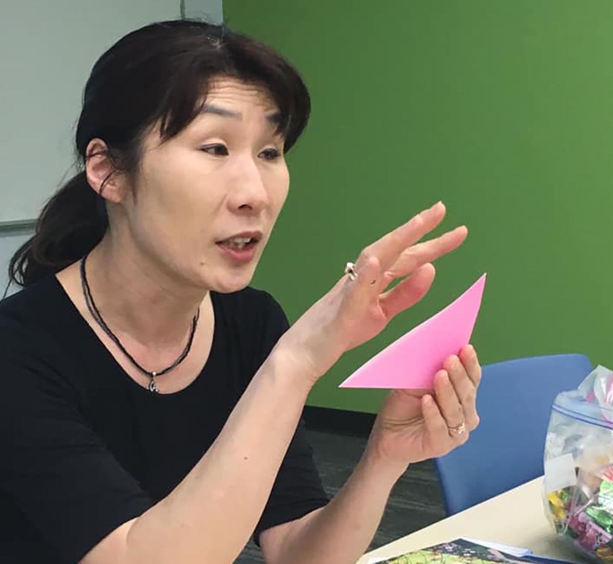 woman explaining origami