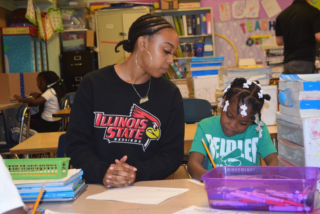 Student teacher working with a child