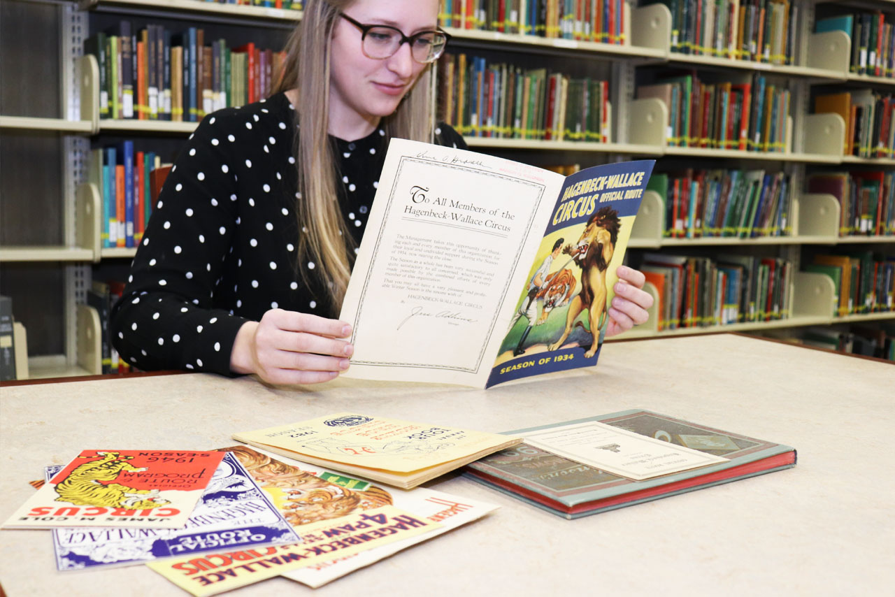 woman looking at circus route books