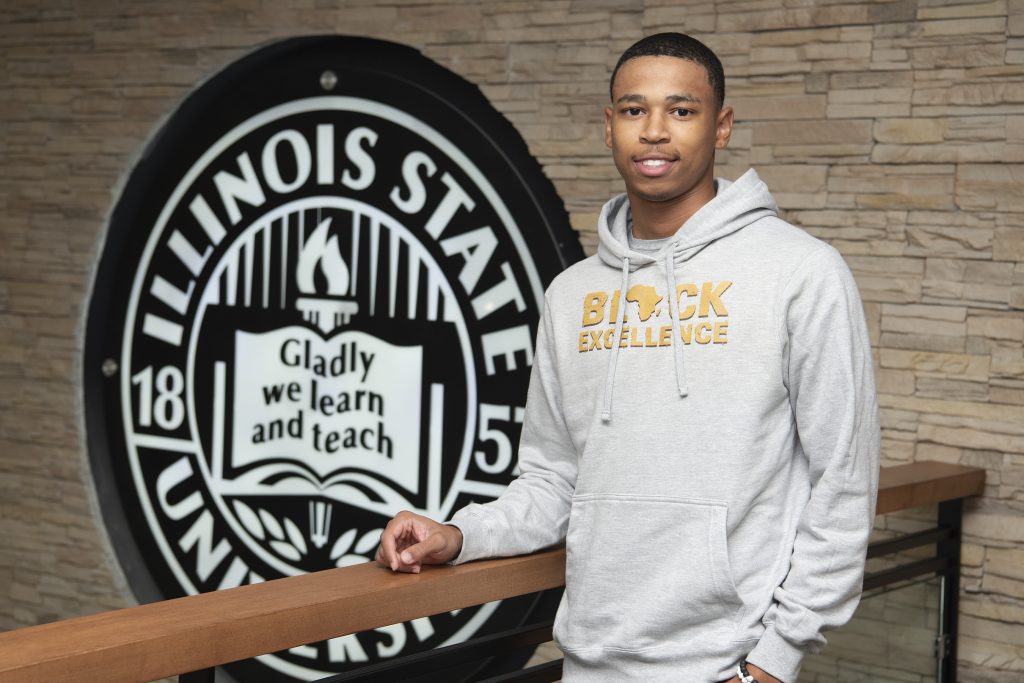 Jaden Echols in front of the ISU logo in the Bone Student Center