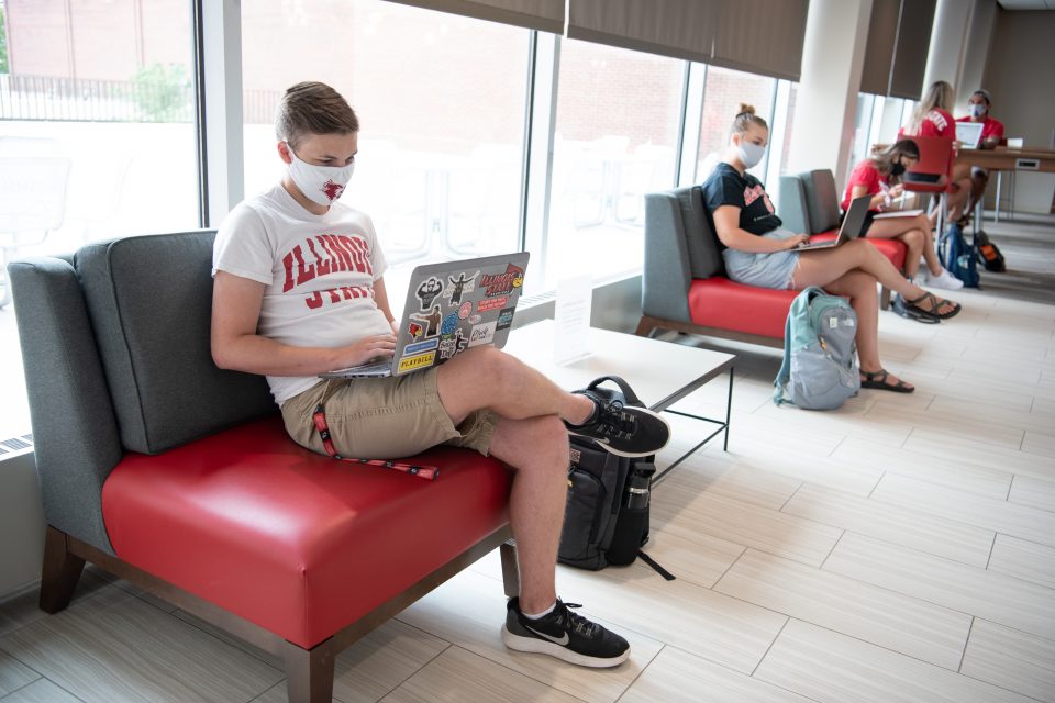 Students with facial coverings distance in the Bone Student Center