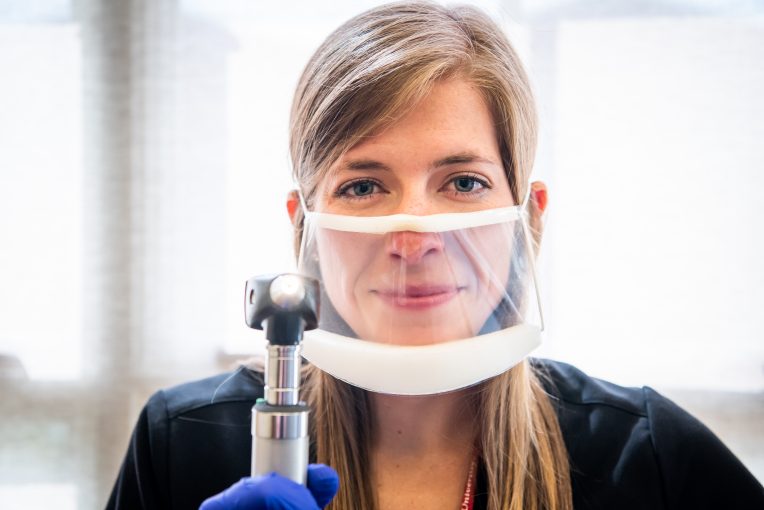Graduate student with see-through mask in speech and hearing clinic