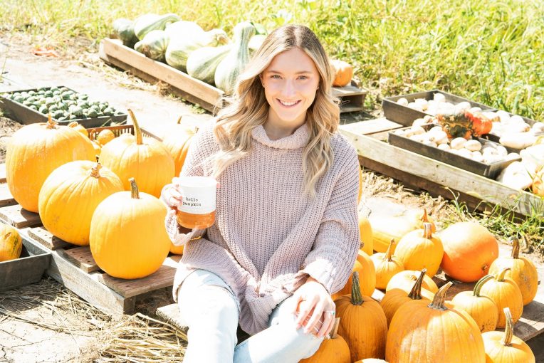 Woman sitting with pumpkins