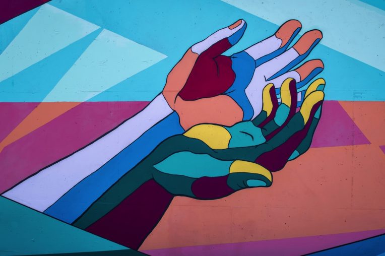 Colorful hands reaching out for help