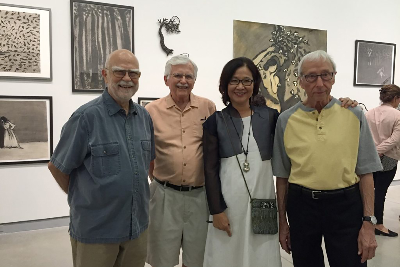 Photo taken at the fall 2016 exhibition Wonsook Kim: Lines of Enchantment. Left to right, Ken Holder, Harold Gregor, Wonsook Kim, and Harold Boyd. Wonsook Kim's artwork is installed on the walls of the University Galleries.