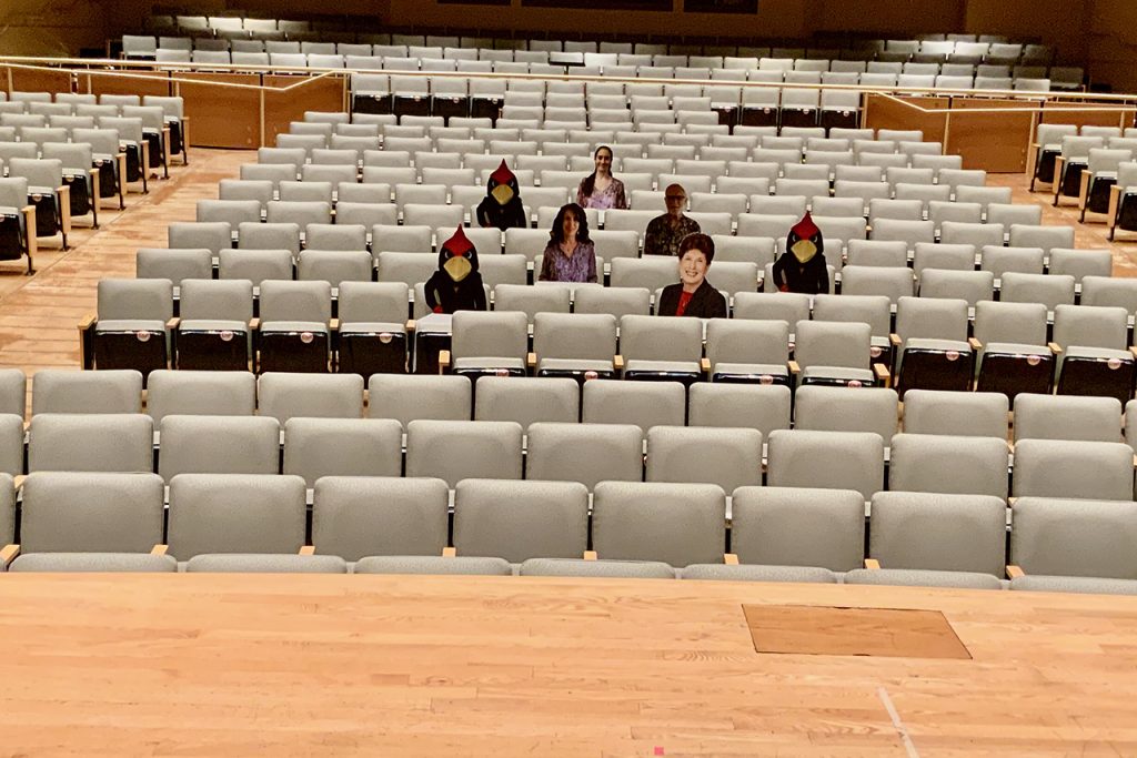 Image of Concert Hall with cutouts of Reggie and individuals filling the seats