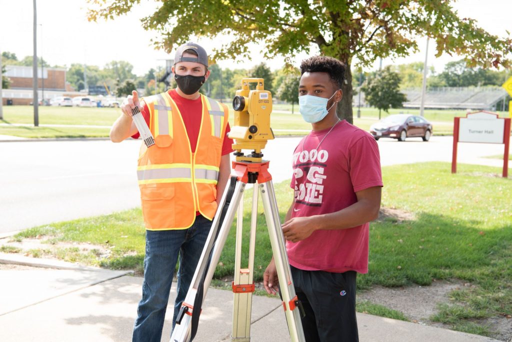 Engineering students survey a location