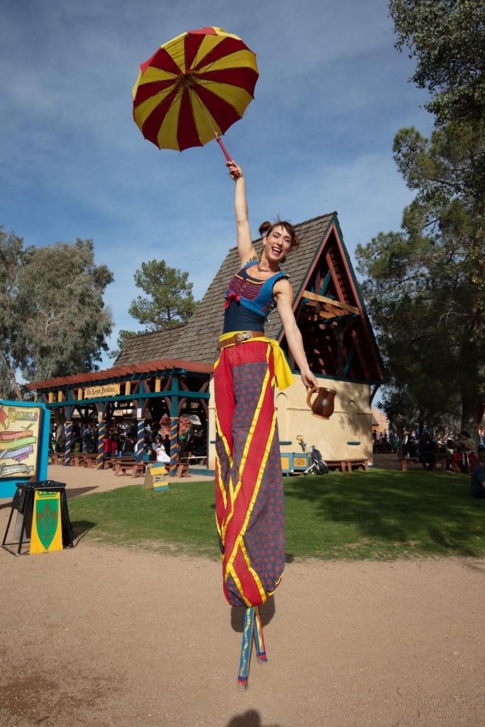 performer standing on stilts in costume