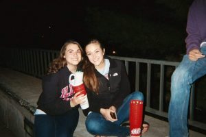 Two women sitting outside at night
