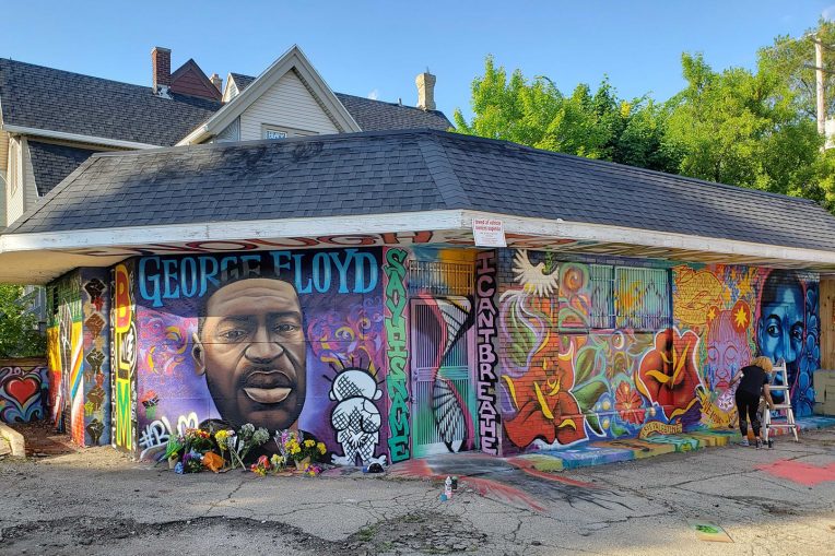 building covered with colorful mural honoring George Floyd