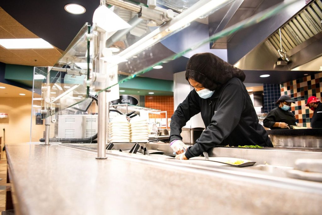 In her role, Divers oversees her fellow student workers while handling tasks such as sanitizing surfaces, refilling machines, preparing food, and working in the back office.