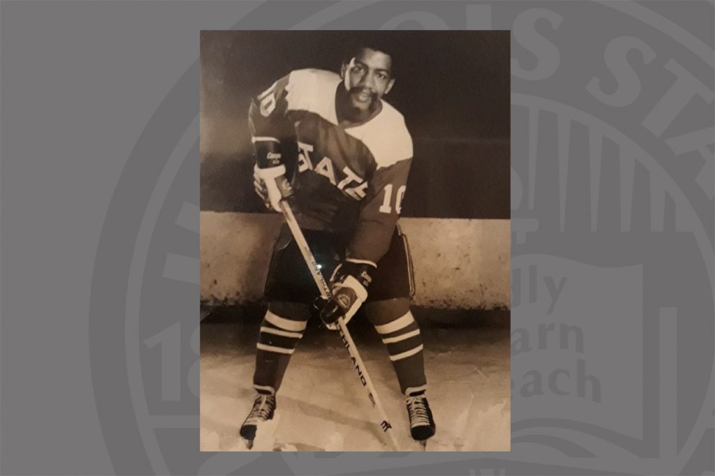 Man in black and white photo playing hockey