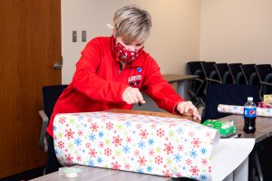 Holiday help wraps a gift.