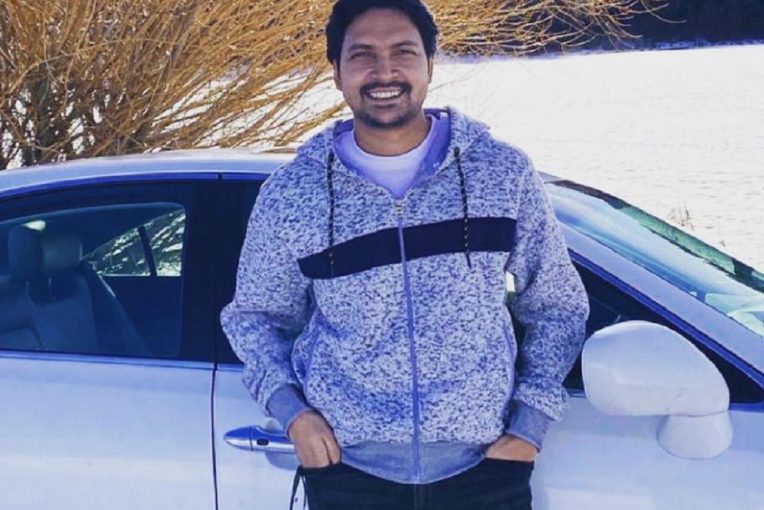 Sohel Rana standing in front of a white car