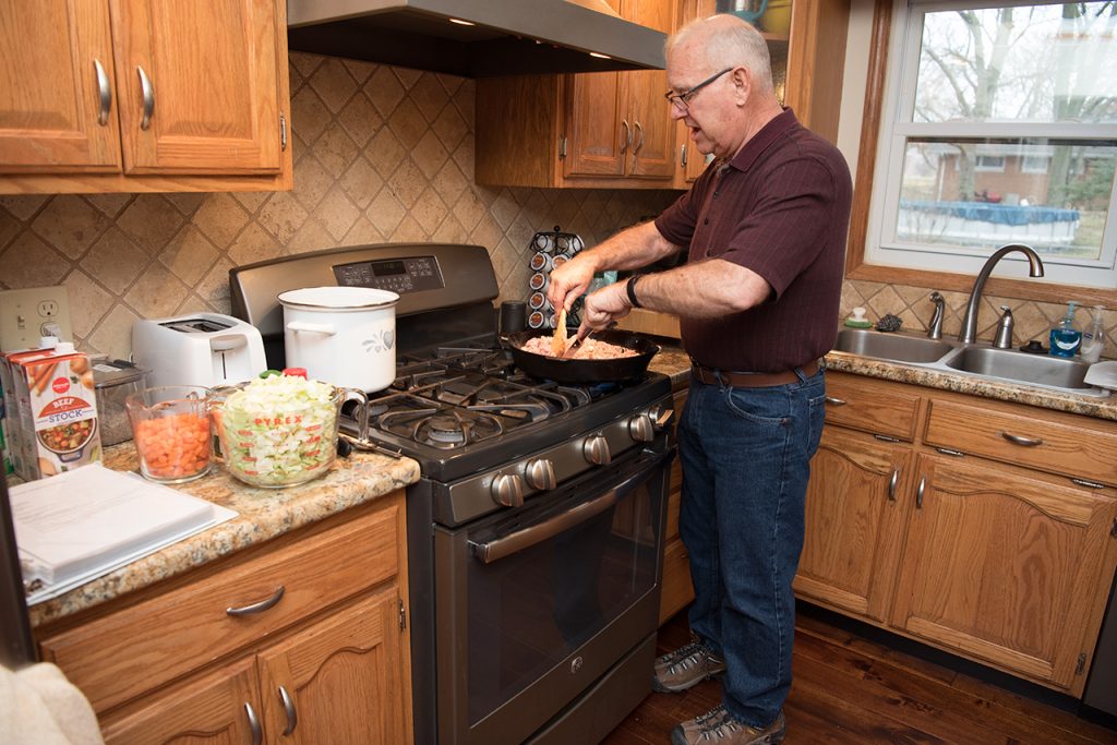 Man browning turkey in his kitchen