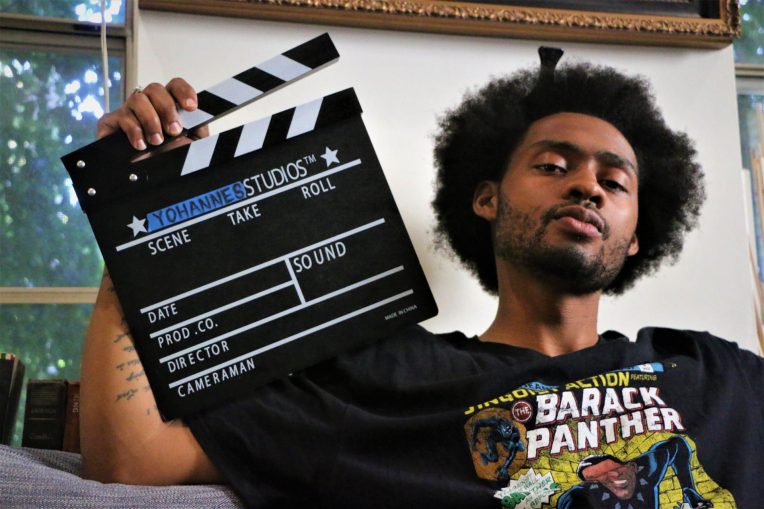 Yohannes Yamassee '16 posing with his clapperboard.