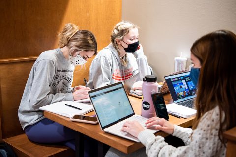 three students studying