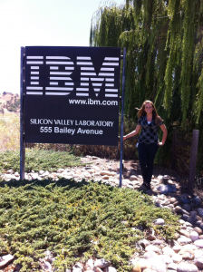 Student stands next to IBM entrance sign in California