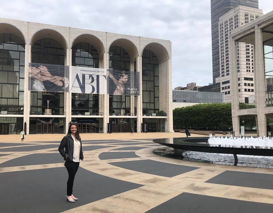 Alumna poses outside the Met Opera