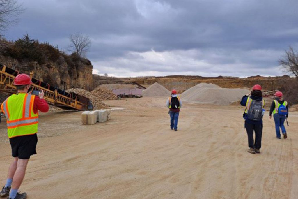 Logan Chapman (far, left) and Jackie Epperson (far, right) explore the Fischer Excavating Quarry. (Photo by Rebecca Brangard)