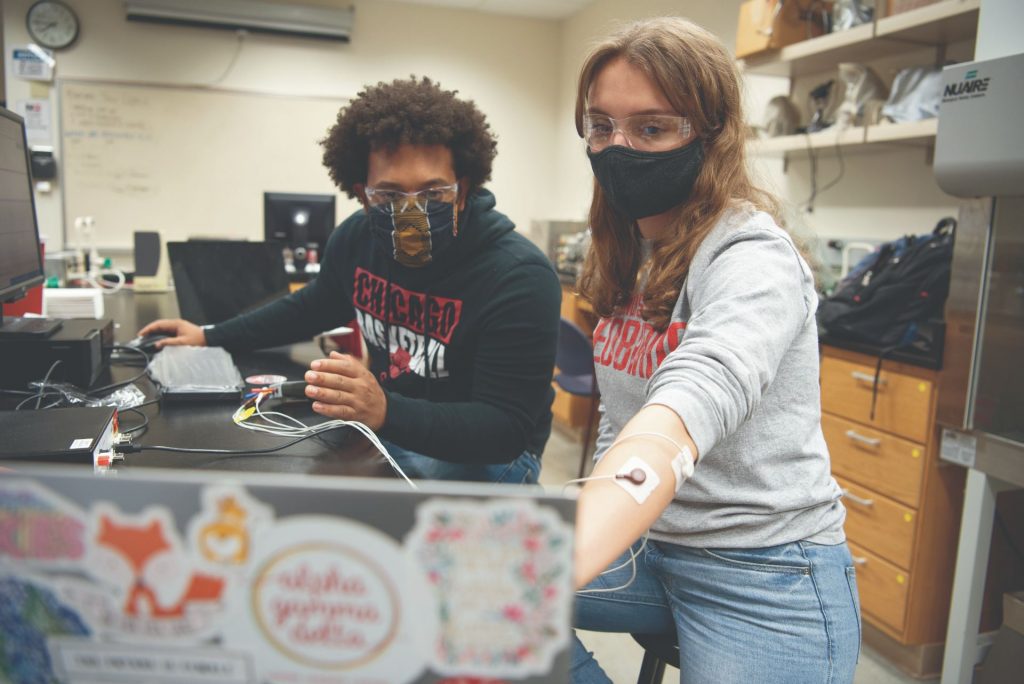 Two students work in a lab together.