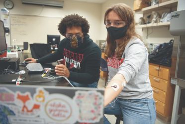 Two students work in a lab together.