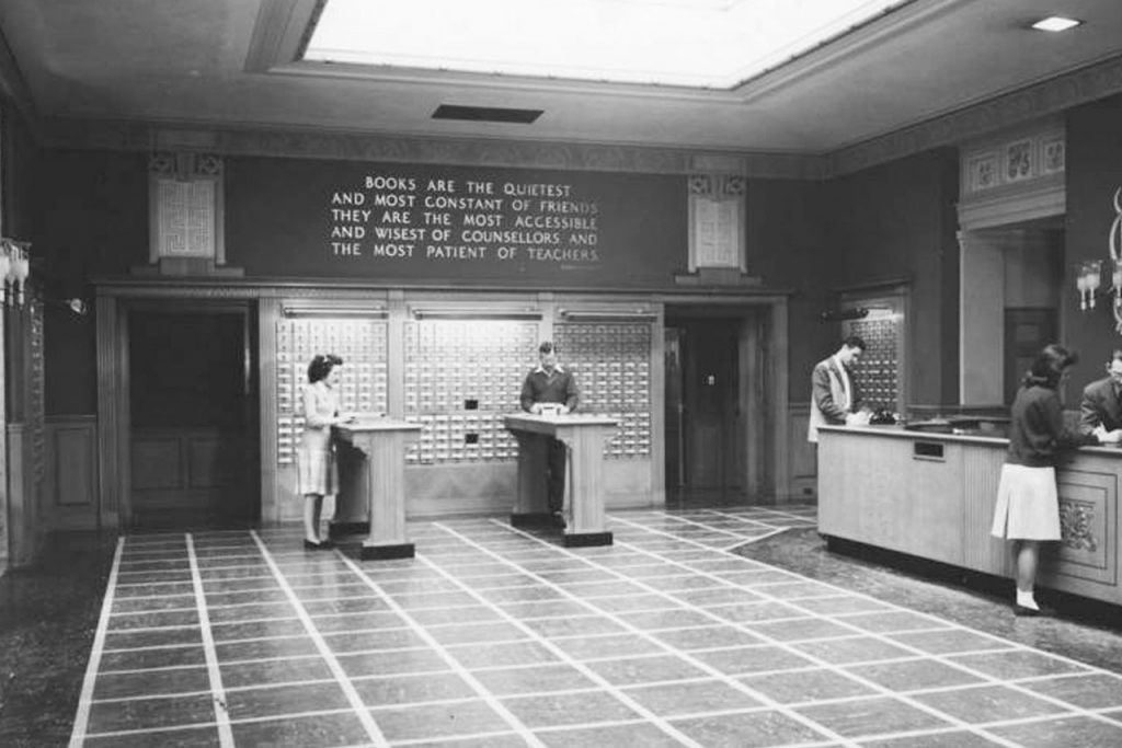Black and white photograph of students standing at the card catalog of Milner Library when it was located in Williams Hall