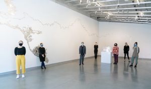Individuals stand within University Galleries